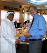 Robert Bradshaw of CMCG presents certificates to students in Abu Dhabi.